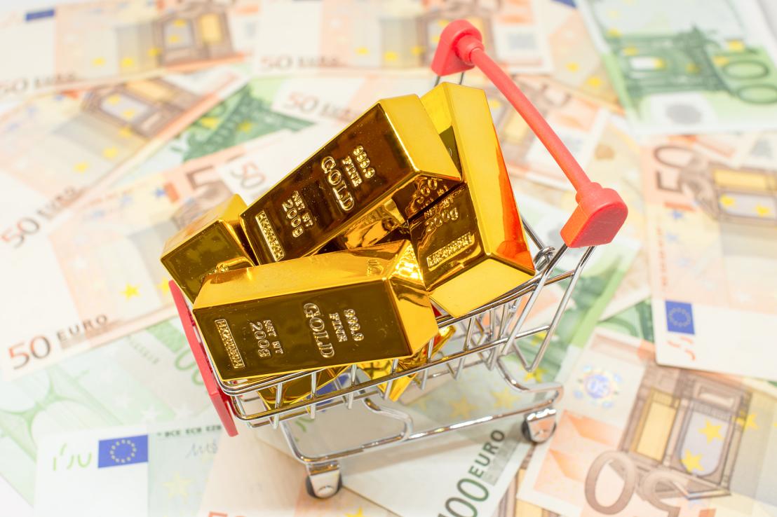 shopping cart with gold bullion bars and euro currency notes security investment buying metaphor co